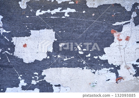 Close up of weathered peeling paint on a wall showing distressed texture 132093885