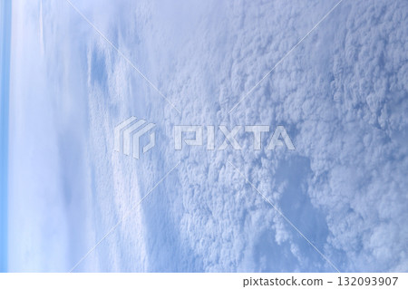 Expansive sky view with fluffy clouds in blue and white from high altitude Expansive sky view with fluffy clouds in blue and white from high altitude 132093907