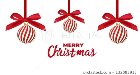 Red and white striped Christmas balls hang on red satin ribbon with bow. 132093915