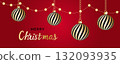 Red and white striped Christmas balls hang on red satin ribbon with bow. 132093935