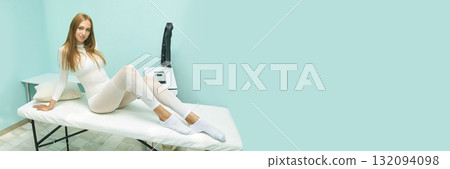 Young caucasian female in white bodysuit relaxing on spa table in aqua room 132094098