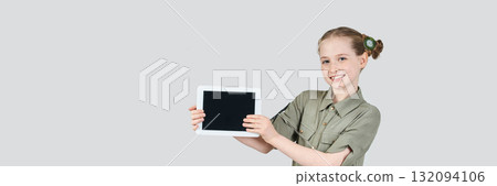Caucasian young female smiling with blank screen tablet in casual outfit 132094106