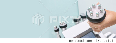 Woman holding cavitation machine probe for beauty treatment in modern spa Woman holding cavitation machine probe for beauty treatment in modern spa 132094191