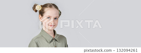 Smiling caucasian young female child with braided hair and green shirt on plain Smiling caucasian young female child with braided hair and green shirt on plain 132094261