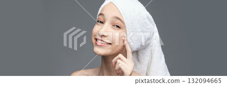 Young caucasian female skincare routine with towel turban and moisturizing Young caucasian female skincare routine with towel turban and moisturizing 132094665