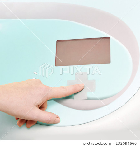 Close-up of hand operating modern medical device with display screen Close-up of hand operating modern medical device with display screen 132094666