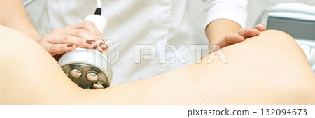 Female receiving cellulite treatment with anti-cellulite device in spa 132094673