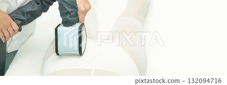 Caucasian female adult undergoing cryotherapy treatment on legs with advanced Caucasian female adult undergoing cryotherapy treatment on legs with advanced 132094716