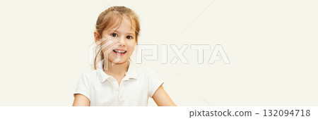 Smiling caucasian young girl in white shirt with light brown hair against soft Smiling caucasian young girl in white shirt with light brown hair against soft 132094718
