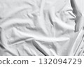 Close up of soft crumpled white fabric with textured shadows and light play 132094729