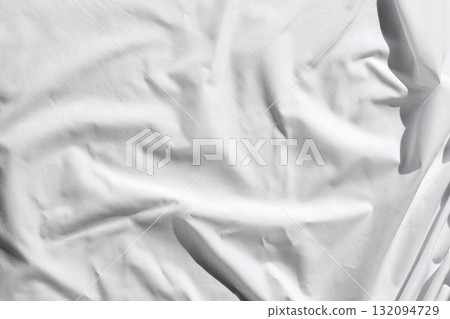Close up of soft crumpled white fabric with textured shadows and light play Close up of soft crumpled white fabric with textured shadows and light play 132094729