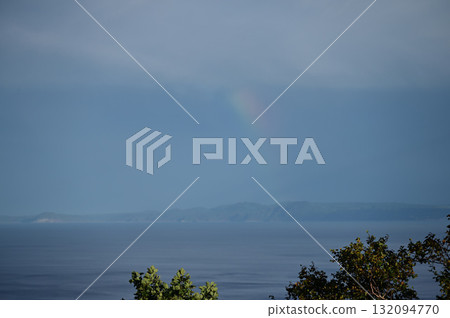 Kunashiri Island and the sea with a rainbow in the sky 132094770