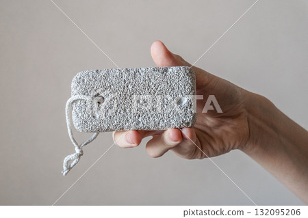 A close-up of a pumice stone for the foot. The background is neutral and simple. 132095206