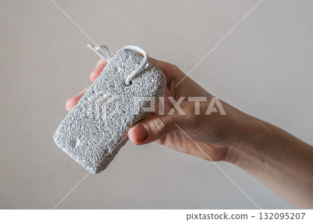 A close-up of a pumice stone for the foot. The background is neutral and simple. 132095207