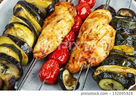 Chicken breast and vegetables skewers. 132095928