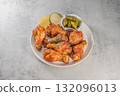 Savor the irresistible allure of these delicious, spicy buffalo chicken wings. Crispy, cooked to perfection and coated in a flavorful sauce, they are sprinkled with sesame seeds 132096013