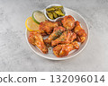 Savor the irresistible allure of these delicious, spicy buffalo chicken wings. Crispy, cooked to perfection and coated in a flavorful sauce, they are sprinkled with sesame seeds 132096014