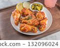Savor the irresistible allure of these delicious, spicy buffalo chicken wings. Crispy, cooked to perfection and coated in a flavorful sauce, they are sprinkled with sesame seeds 132096024