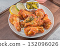 Savor the irresistible allure of these delicious, spicy buffalo chicken wings. Crispy, cooked to perfection and coated in a flavorful sauce, they are sprinkled with sesame seeds 132096026