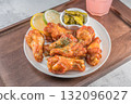 Savor the irresistible allure of these delicious, spicy buffalo chicken wings. Crispy, cooked to perfection and coated in a flavorful sauce, they are sprinkled with sesame seeds 132096027