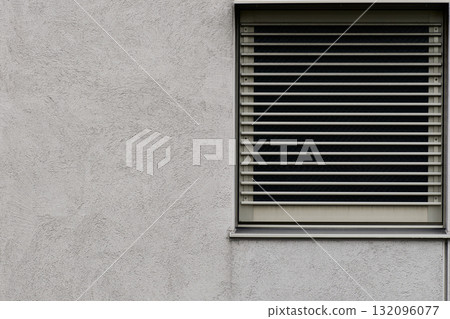 A concrete wall with a beautiful brushed pattern and a metal grid. Gray, rough textured background 132096077
