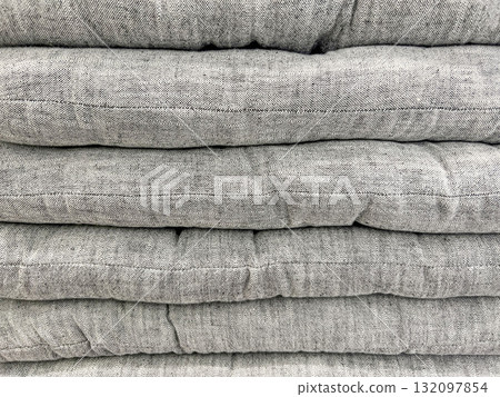 Stack of soft gray flat cushions neatly piled Stack of soft gray flat cushions neatly piled 132097854