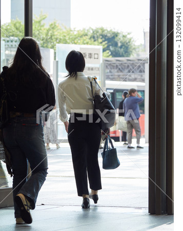 A female office worker commuting to work leaving the east exit of Kanazawa Station on a summer morning 132099414