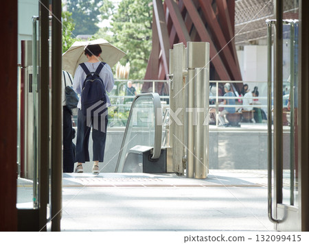 A female office worker commuting to work leaving the east exit of Kanazawa Station on a summer morning A female office worker commuting to work leaving the east exit of Kanazawa Station on a summer morning 132099415