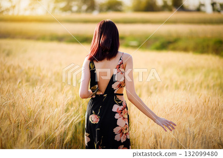 Charming asian woman in wheat field with soft sunset 132099480