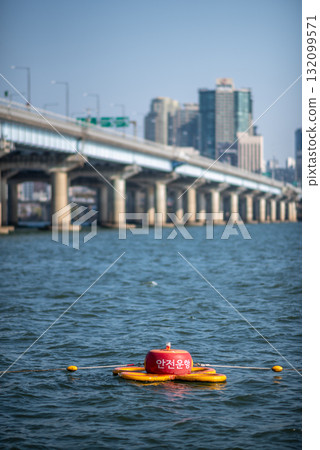 A buoy floating in Han river with cityscape in the background in Seoul, South Korea 132099571