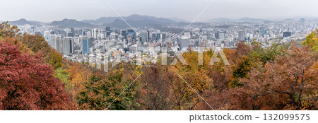 Aerial panoramic cityscape view of downtown Seoul, capital of South Korea with Autumn foliage in the foreground Aerial panoramic cityscape view of downtown Seoul, capital of South Korea with Autumn foliage in the foreground 132099575