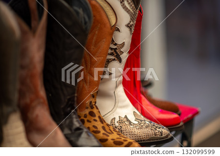 A row of colorful cowboy boots with various patterns 132099599