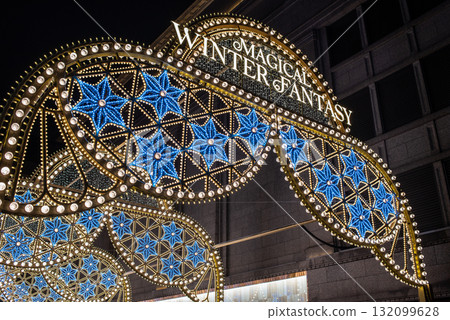 Illuminated winter festival sign with intricate blue and gold lights Illuminated winter festival sign with intricate blue and gold lights 132099628