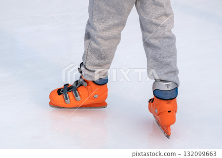 Person ice skating with orange skates on a rink in Seoul, South Korea 132099663