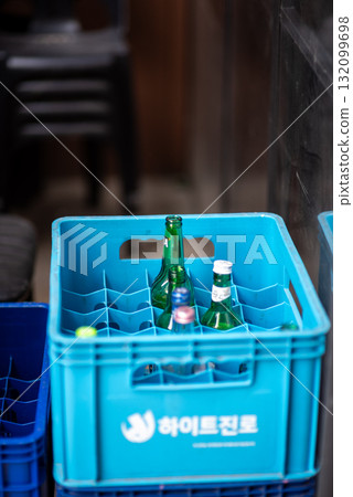 Blue plastic crate with empty glass bottles inside in bar street in Itaewon district in Seoul, South Korea Blue plastic crate with empty glass bottles inside in bar street in Itaewon district in Seoul, South Korea 132099698