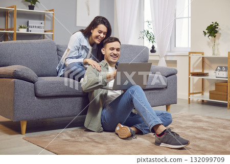 Overjoyed man and woman at home with laptop, triumph win online lottery, shopping Overjoyed man and woman at home with laptop, triumph win online lottery, shopping 132099709