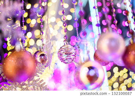 Colorful Baubles and Balls hanging decorated on christmas tree with bokeh light background 132100087