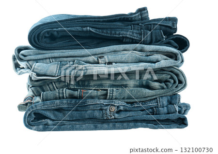 Folded jeans in different shades of blue stacked neatly. Folded jeans in different shades of blue stacked neatly. 132100730