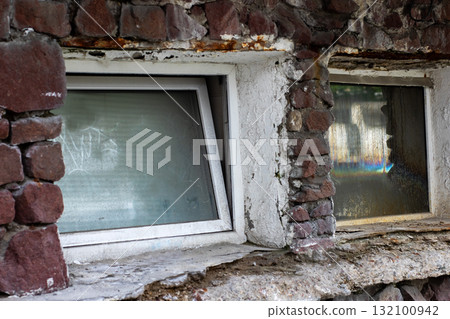 Rustic Basement Windows in Stone Wall with Moisture and Texture 132100942