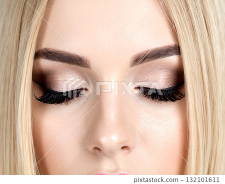 Close-up of a woman with highlighted eye makeup 132101611