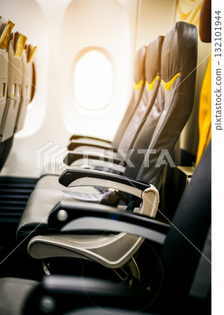Empty seats and window inside an aircraft , Inside the plane in sunrise skyEmpty seats and window inside an aircraft , Inside the plane in sunrise sky Empty seats and window inside an aircraft , Inside the plane in sunrise skyEmpty seats and window inside an aircraft , Inside the plane in sunrise sky 132101944