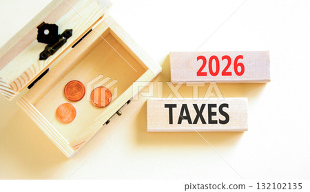 2026 taxes new year symbol. Concept words 2026 taxes on beautiful wooden blocks. Beautiful white paper background. Beautiful wooden chest with coins. Business 2026 taxes new year concept. Copy space. 132102135