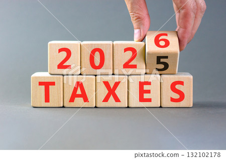 2026 taxes new year symbol. Concept words 2026 taxes on beautiful wooden blocks. Beautiful grey paper background. Businessman's hand. Business and 2026 taxes new year concept. Copy space. 132102178