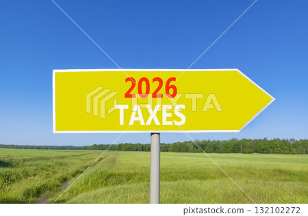 2026 taxes new year symbol. Concept words 2026 taxes on beautiful yellow road sign. Beautiful green grass field forest and blue sky background. Business and 2026 taxes new year concept. Copy space. 132102272