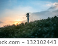 silhouette of happy woman relaxing on mountain hill  in summer sunset sky happy girl enjoying freedom and life raising arms feeling free 132102443