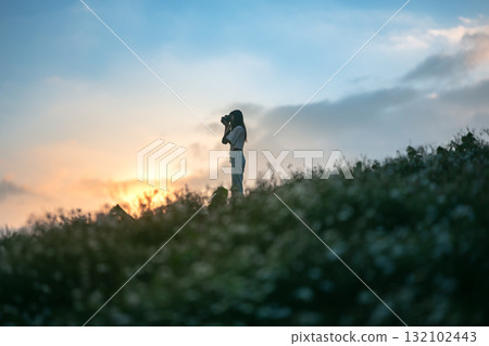 silhouette of happy woman relaxing on mountain hill  in summer sunset sky happy girl enjoying freedom and life raising arms feeling free 132102443