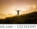 silhouette of happy woman relaxing on mountain hill  in summer sunset sky happy girl enjoying freedom and life raising arms feeling free 132102445