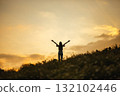 silhouette of happy woman relaxing on mountain hill  in summer sunset sky happy girl enjoying freedom and life raising arms feeling free 132102446