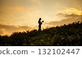 silhouette of happy woman relaxing on mountain hill  in summer sunset sky happy girl enjoying freedom and life raising arms feeling free 132102447