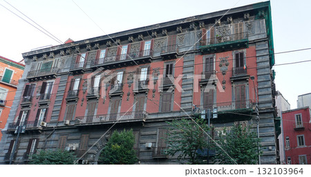 Naples, Italy - Colorful facades in a narrow street in old town of historic italian metropole Naples. Balconys of typical residential buildings at Naples, Italy 132103964